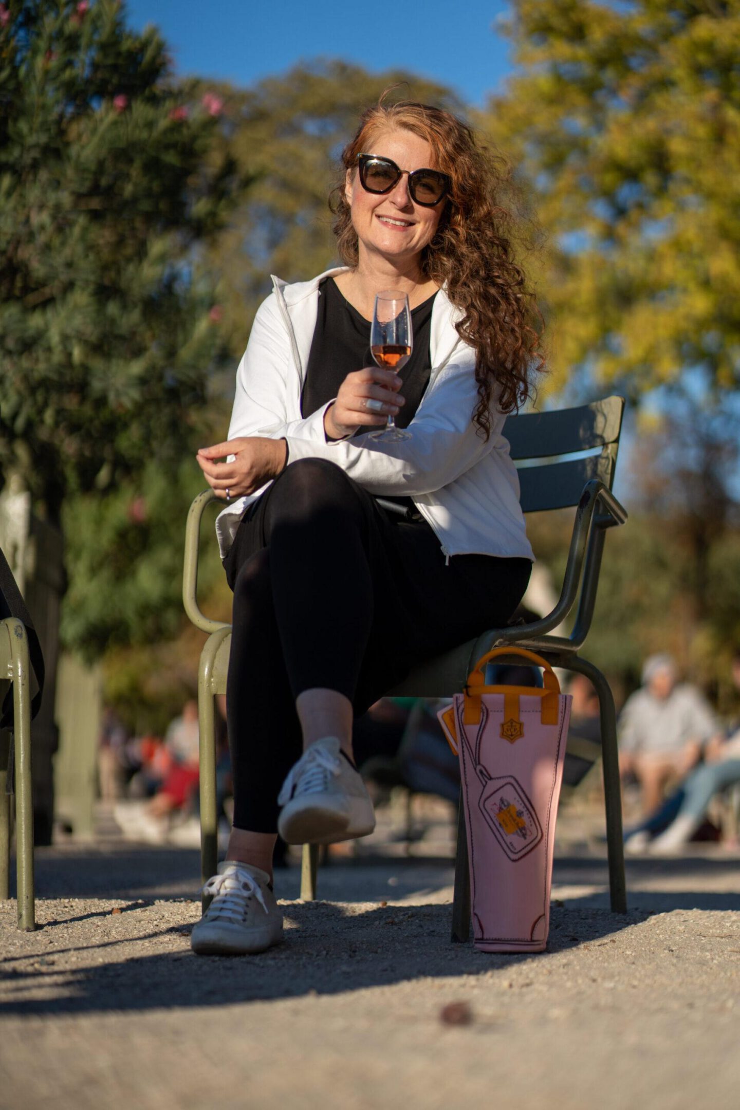 Fashion blogger with champagne in the Jardin du Luxembourg, Paris