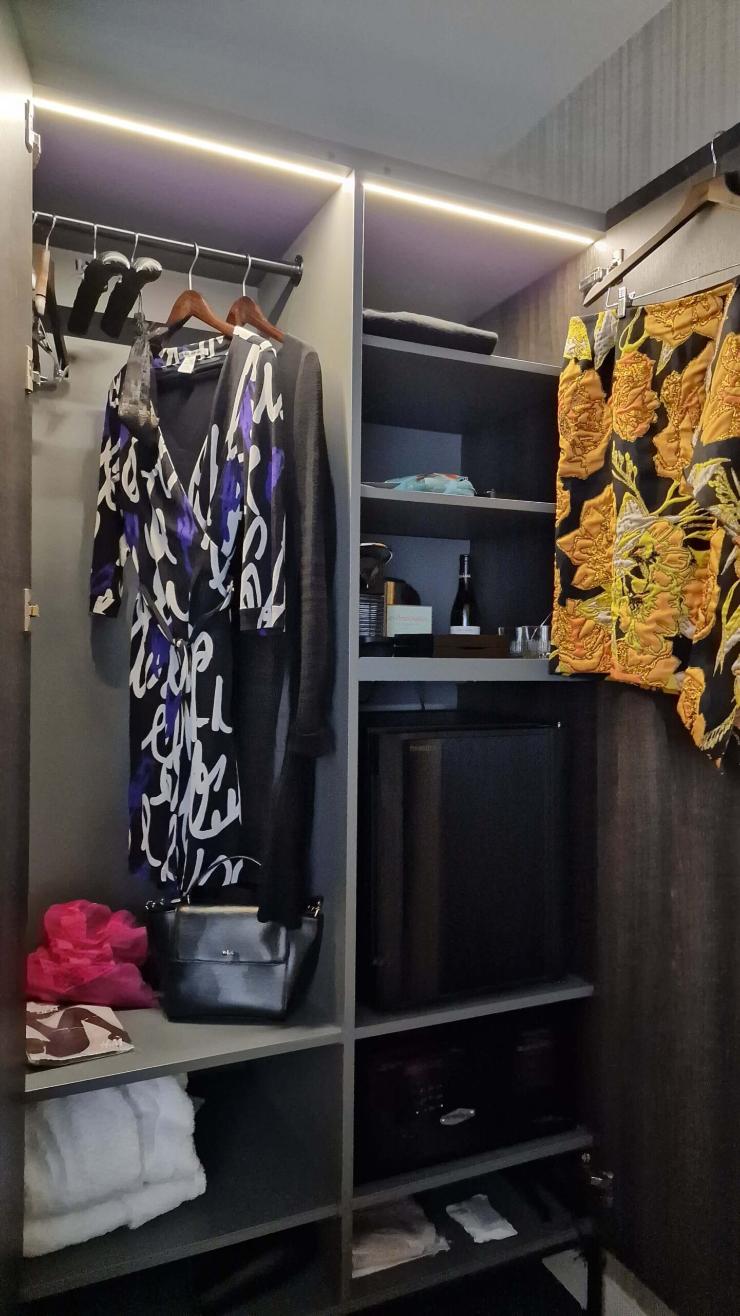 City-break capsule wardrobe hanging in a hotel room